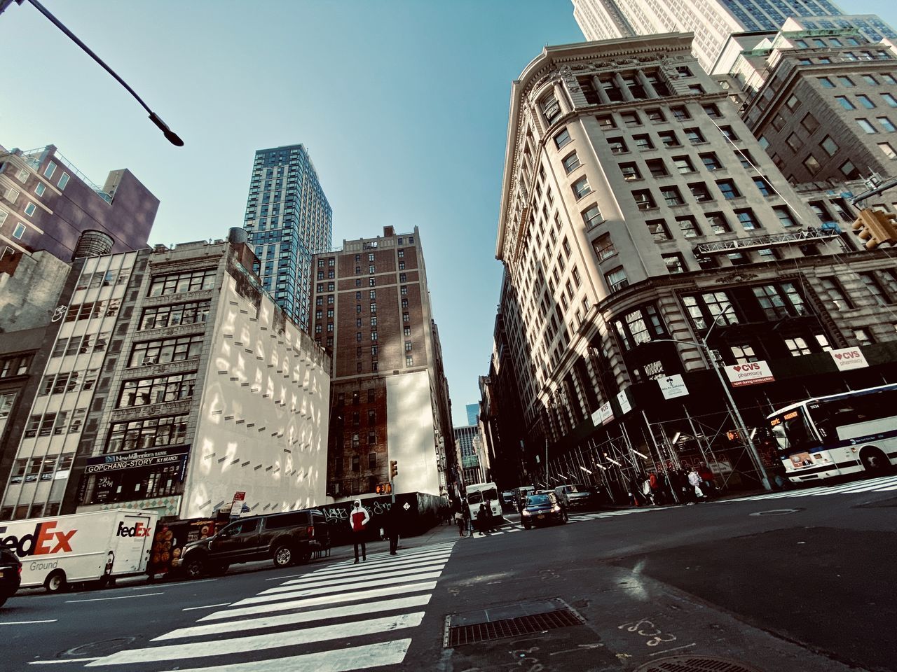 CITY STREET AMIDST MODERN BUILDINGS AGAINST SKY IN BACKGROUND