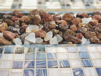 High angle view of stones by tiled floor