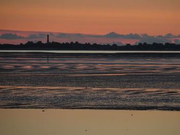 Scenic view of beach against sky during sunset