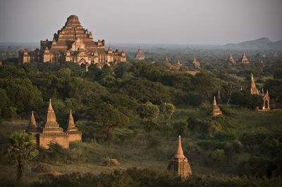 Statue in temple against sky