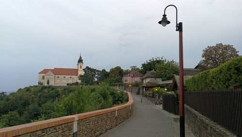 Street amidst buildings against sky