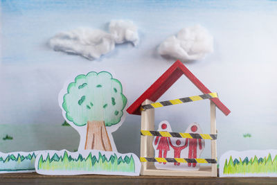 Hand drawn of trees, grass and a family inside a house. concept of lockdown in a global crisis