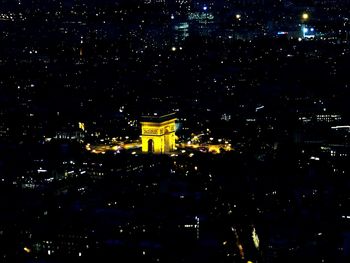 High angle view of city lit up at night