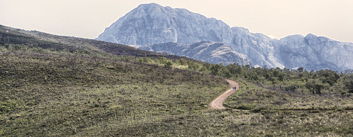 Scenic view of mountain road against clear sky