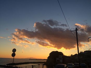 Silhouette of street light at sunset