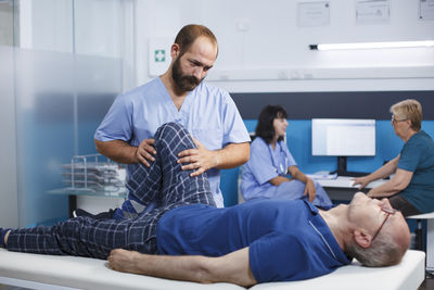 Side view of doctor examining patient in office