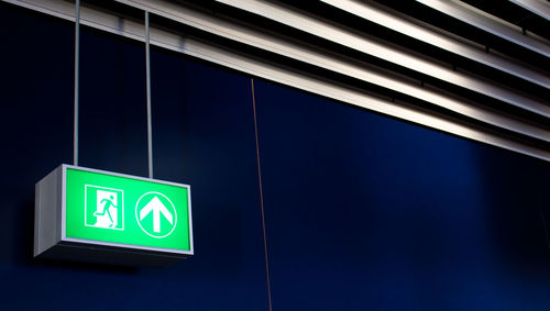 Emergency exit sign on wall