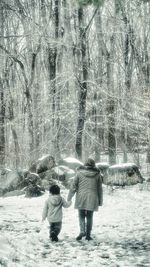 People walking on snow covered landscape