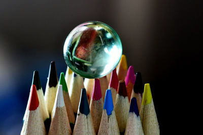 Close-up of multi colored pencils against gray background