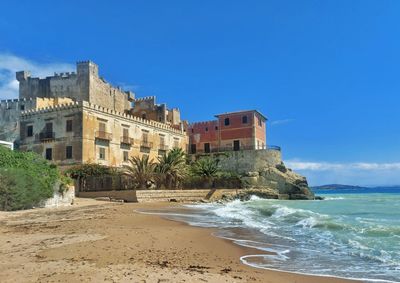 Scenic view of beach against clear blue sky