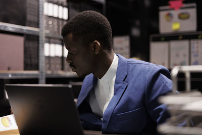 Young man using laptop at office