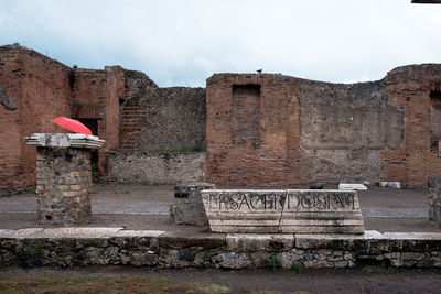 View of old building against cloudy sky