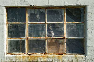 Broken glass window of old building