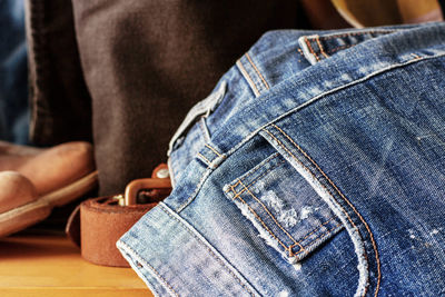 Close-up of jeans on floor