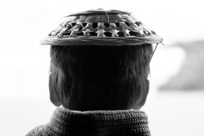 Rear view of man wearing wicker hat