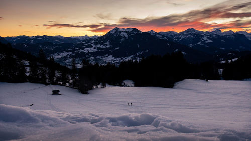 Snow covered mountains against sky during sunset in the ski area austria, vorarlberg, bödele