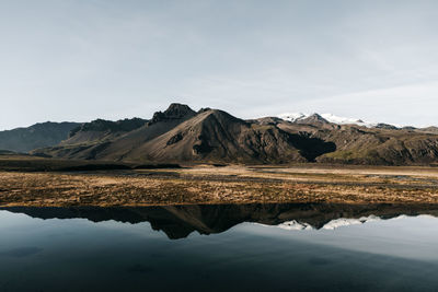 Reflection of mountain range in lake against sky