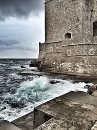 Scenic view of sea against cloudy sky