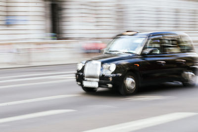 Uk, england, london, blurred motion of taxi driving along city street