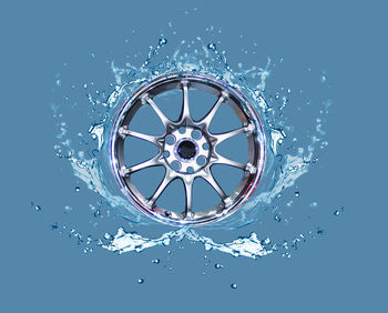 Close-up of water splashing against blue background