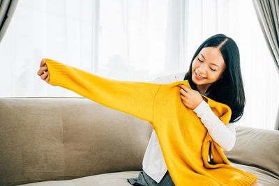 Portrait of young woman using mobile phone