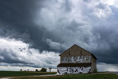 House on field against sky