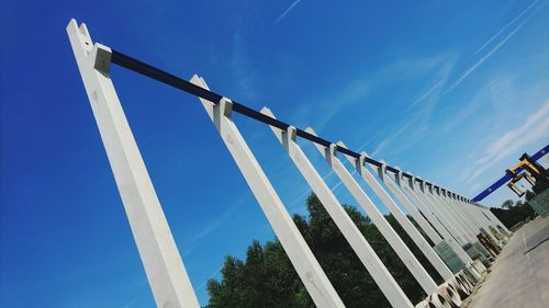 Low angle view of windmill against blue sky