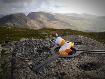 Stuffed toy on rock against sky