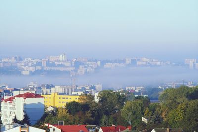 High angle view of buildings in city against sky