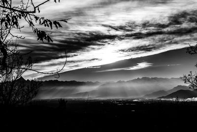 Scenic view of dramatic sky over silhouette landscape