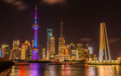 Illuminated buildings in city at night