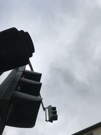 Low angle view of road signal against sky