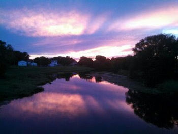 Scenic view of lake against sky at sunset