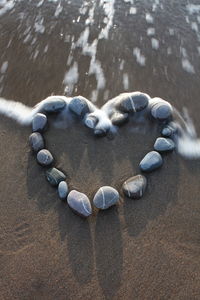 High angle view of stones on wet sand