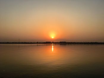 Scenic view of lake against sky during sunset