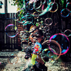 Close-up of boy playing with bubbles