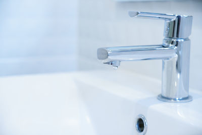 Close-up of faucet in bathroom