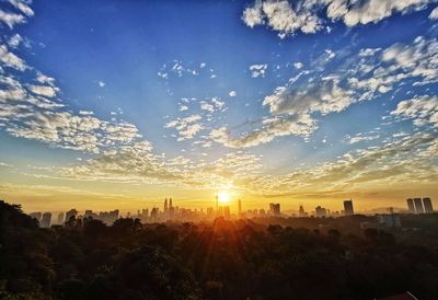 Scenic view of buildings against sky during sunset