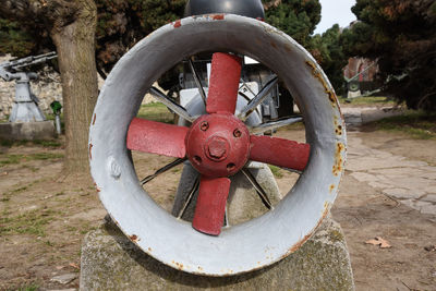 Close-up of rusty wheel on field