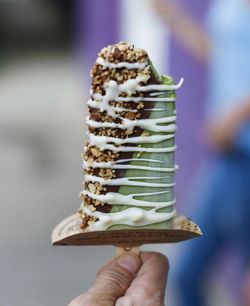 Close-up of hand holding ice cream