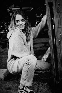 Portrait of smiling woman sitting outdoors