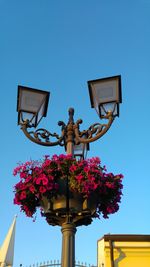Low angle view of lamp post against blue sky