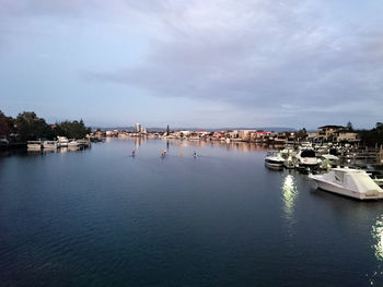 View of harbor against cloudy sky