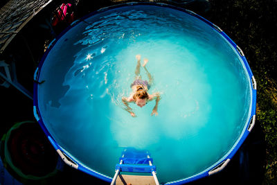 High angle view of woman swimming in pool