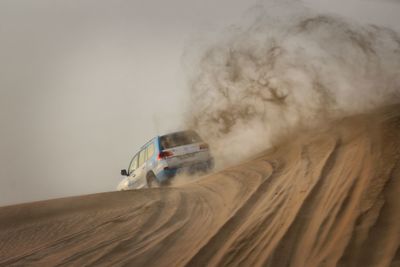 Low angle view of car in desert against sky