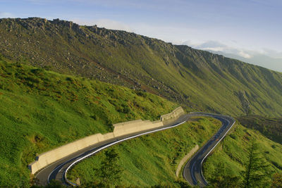 High angle view of road by mountain against sky