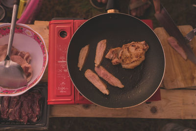 High angle view of meat in cooking pan on table