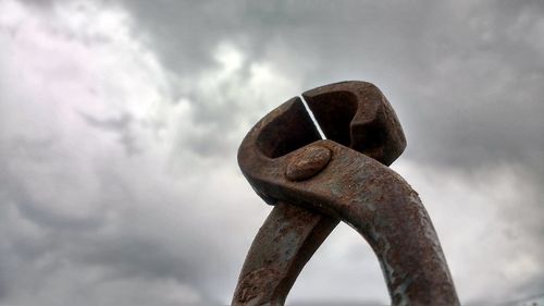 Close-up of rusty metal against sky