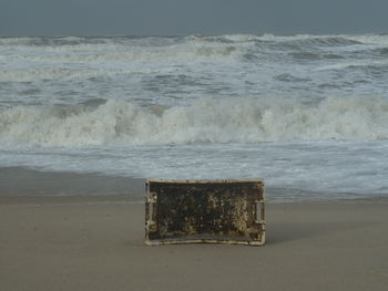 Lifeguard hut on beach against sky