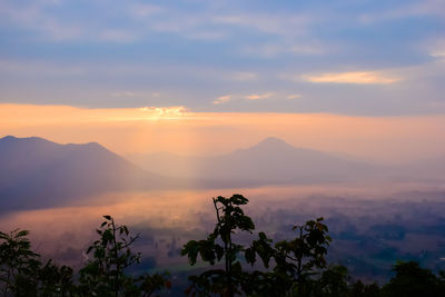 Scenic view of silhouette mountains against sky at sunset